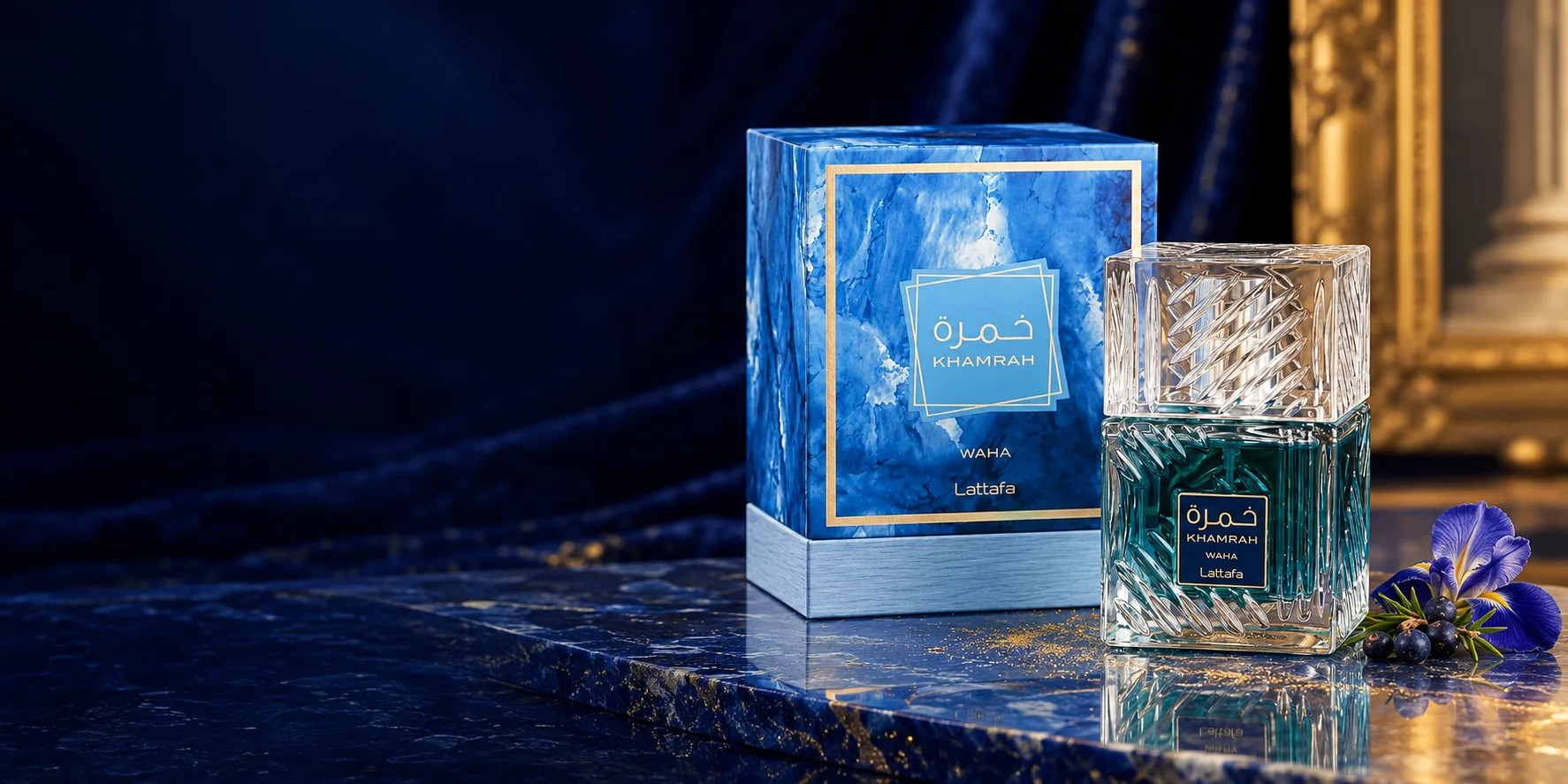 Khamrah Waha in teal cut glass with its blue marbled box and gold borders, on lapis stone with iris and juniper. Concept image.